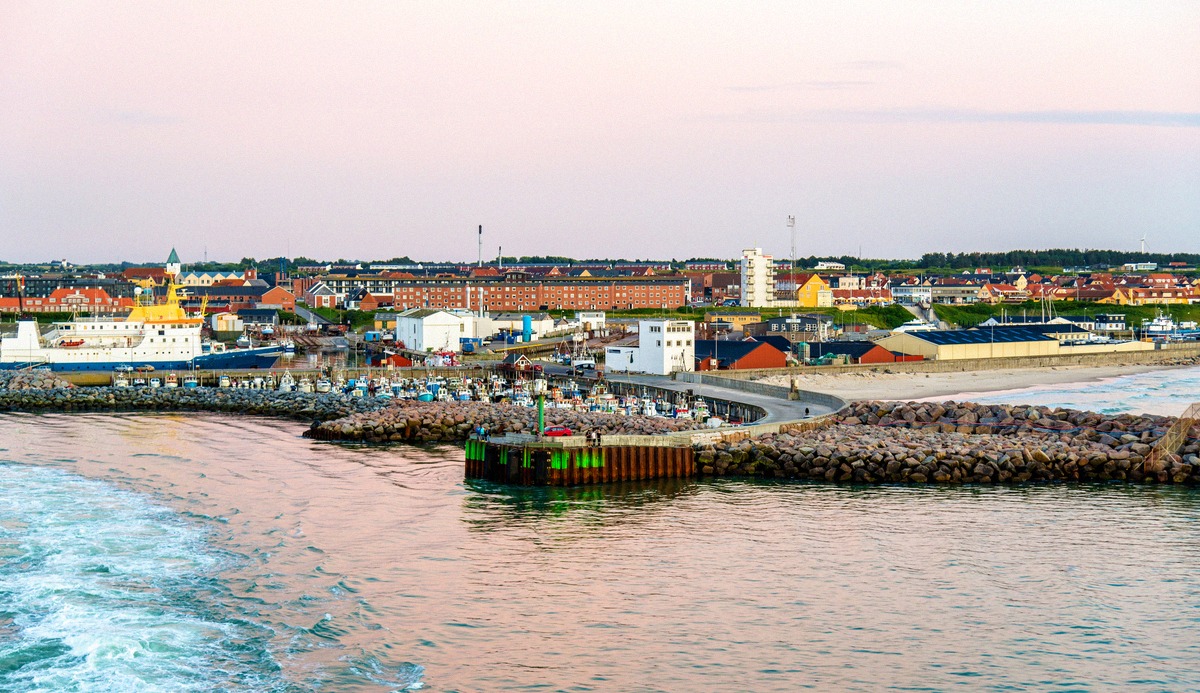 Hirtshals Ferry Port with breakwaters and beacon in the evening light